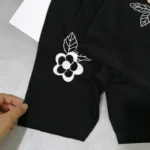 تیشرت شلوارک دخترانه مشکی گل برجسته مناسب 0 تا 5 سال